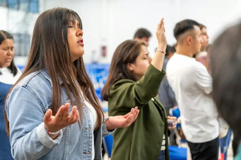 Woman with hands raised worshipping