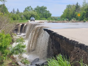 truck driving towards a washed out section of highway in the swan river valley