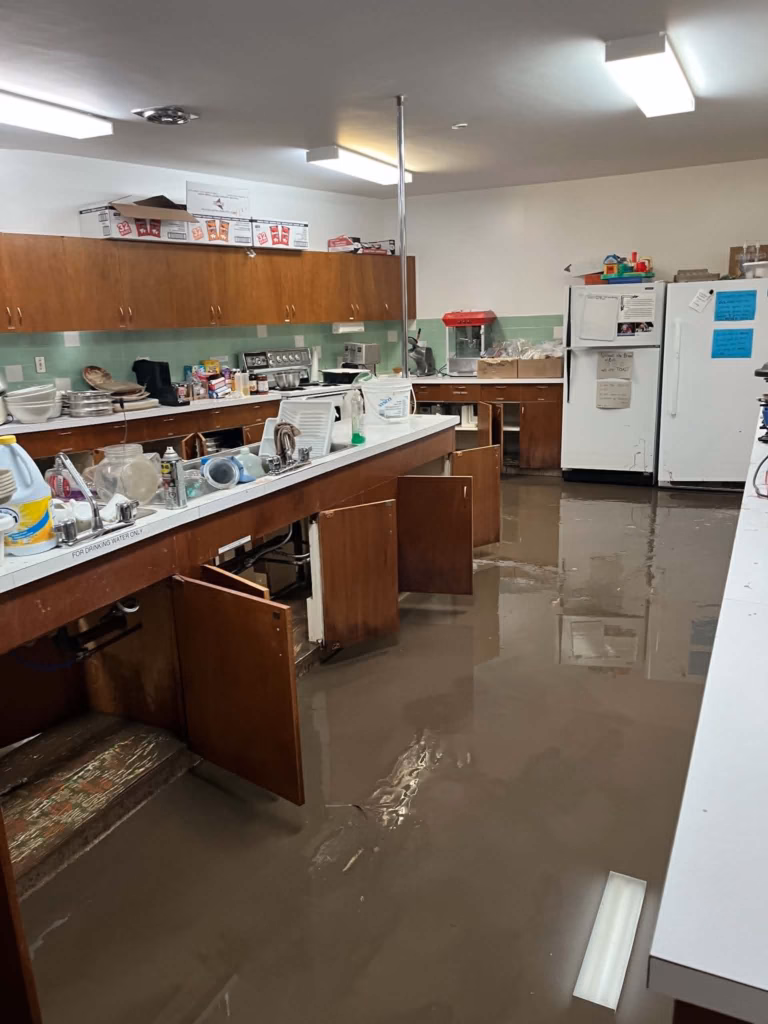 Flooded kitchen with water damaged cabinets